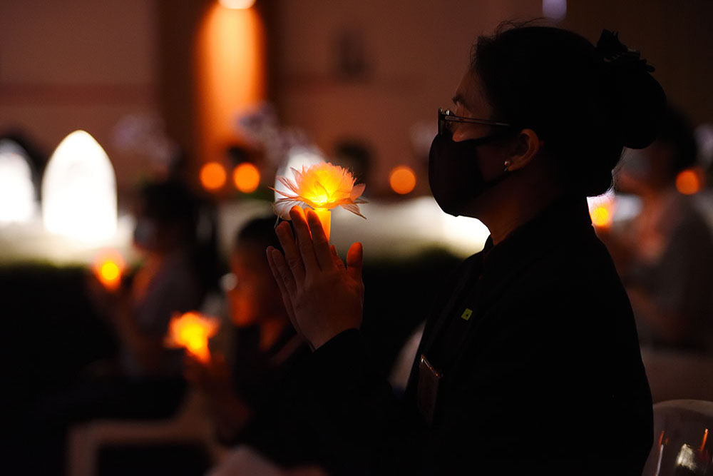 志工手握莲花心灯，齐心唱诵《祈祷》。（摄 / 黎东兴）